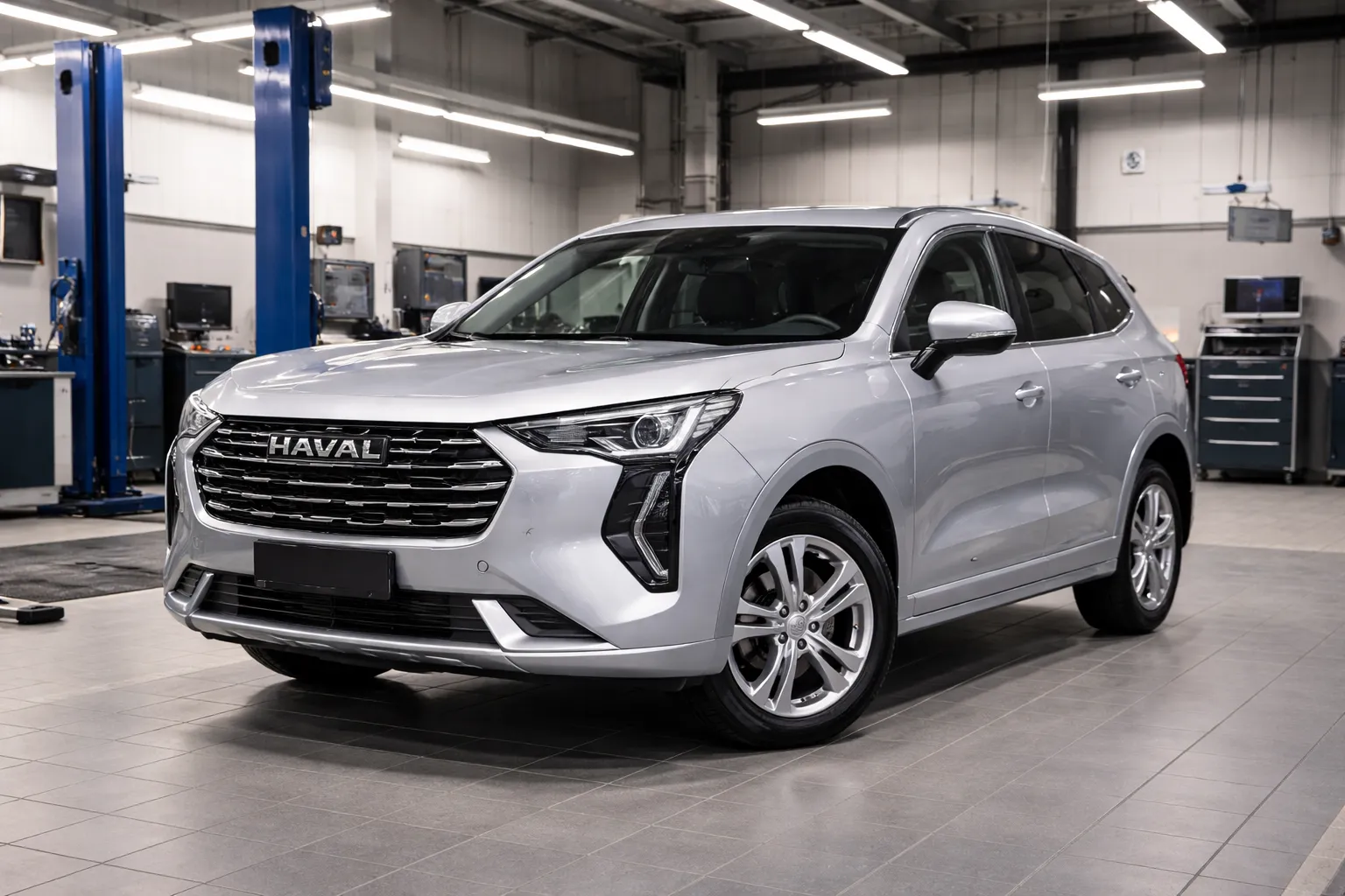 Silver Haval Jolion parked inside a modern service garage with lifts and tools, ready for a Haval Jolion AC condenser replacement to restore strong cooling.