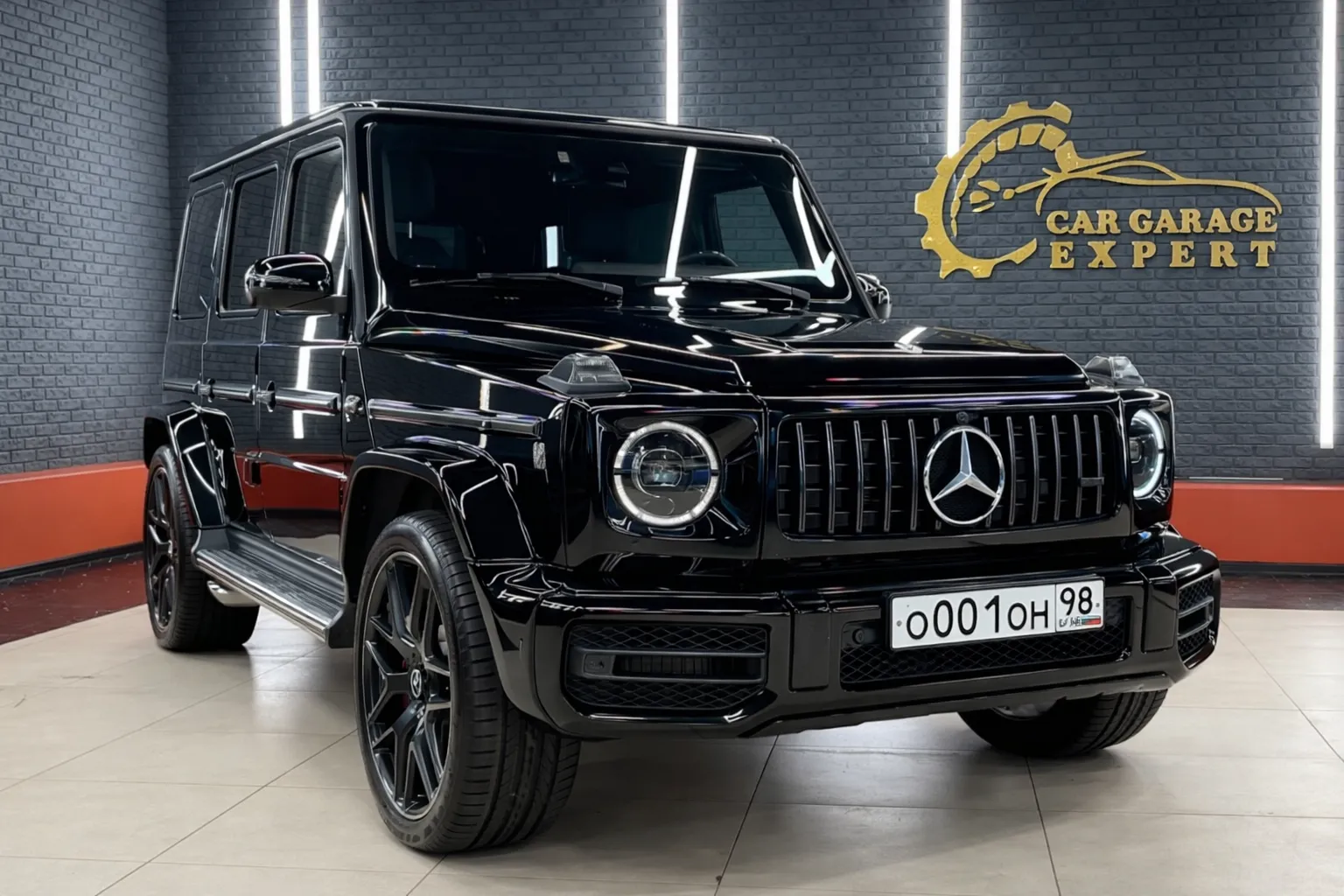 Black Mercedes-Benz G-Class SUV displayed inside a modern garage showroom with LED lighting and representing a professional Mercedes G63 service environment for luxury vehicle maintenance.