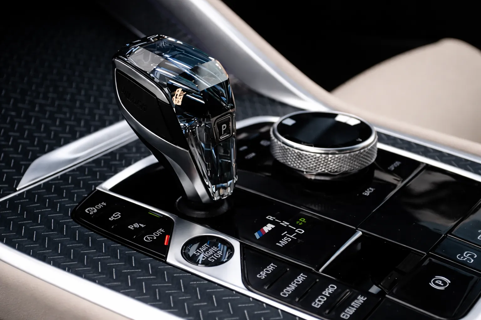 Close-up of a luxury car’s center console with a crystal gear selector and drive mode controls, highlighting smooth performance and precision after a BMW X5 gearbox service.