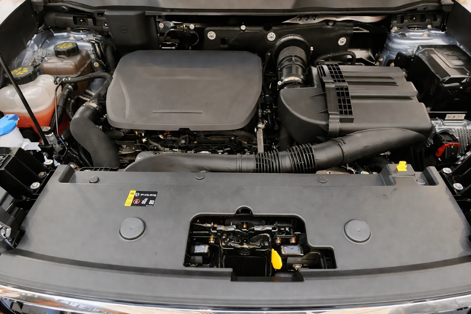 Clean and well-organized car engine bay with visible components and air intake system, representing professional Haval engine repair in Dubai for reliable performance and maintenance.