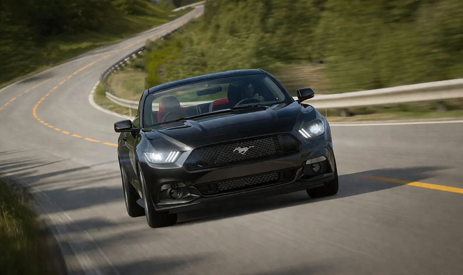 Black sports car driving at high speed on a winding road, showcasing performance and handling, ideal for services offered by American Auto Repair Dubai.